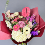 Serene Petals Symphony bouquet with pastel gerbera daisies, hydrangeas, and burgundy wrap – luxury floral arrangement in Dubai.