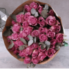 A stunning bouquet of 12 premium purple roses with eucalyptus leaves, perfect for gifting and flower delivery in Dubai.