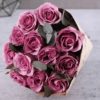 A stunning bouquet of 12 premium Purple Rose Elegance with eucalyptus leaves, perfect for gifting and flower delivery in Dubai.