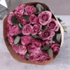 A stunning bouquet of 12 premium purple roses with eucalyptus leaves, perfect for gifting and flower delivery in Dubai.