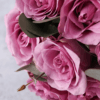 A stunning bouquet of 12 premium purple roses with eucalyptus leaves, perfect for gifting and flower delivery in Dubai