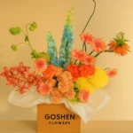 Desert Carnival is a vibrant mixed flower bouquet with yellow, coral, pink, and blue blooms in luxury box – available for same-day delivery in Dubai and UAE.