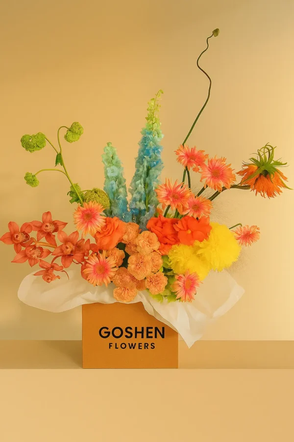 Desert Carnival is a vibrant mixed flower bouquet with yellow, coral, pink, and blue blooms in luxury box – available for same-day delivery in Dubai and UAE.