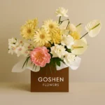 golden grace bouquet with yellow gerberas, white roses, pink peony and orchids in a brown gift box – luxury flower delivery in Dubai.
