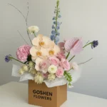 Sahara Blush a luxury blush pink bouquet with orchids and carnations in white wrapping – perfect for birthdays, anniversaries, and flower delivery in Dubai.