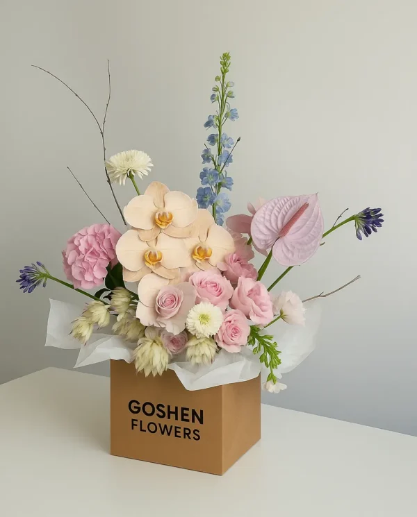 Sahara Blush a luxury blush pink bouquet with orchids and carnations in white wrapping – perfect for birthdays, anniversaries, and flower delivery in Dubai.