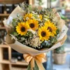 Golden Glow sunflower bouquet with daisies, baby’s breath, and eucalyptus – available for flower delivery in Dubai UAE