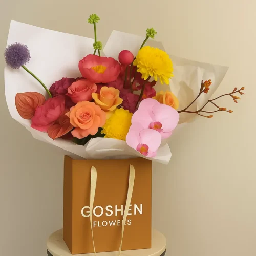 Sunset Mirage is a luxury mixed flower bouquet with orchids, roses, ranunculus, and chrysanthemums in a kraft bag, available for flower delivery in Dubai, UAE